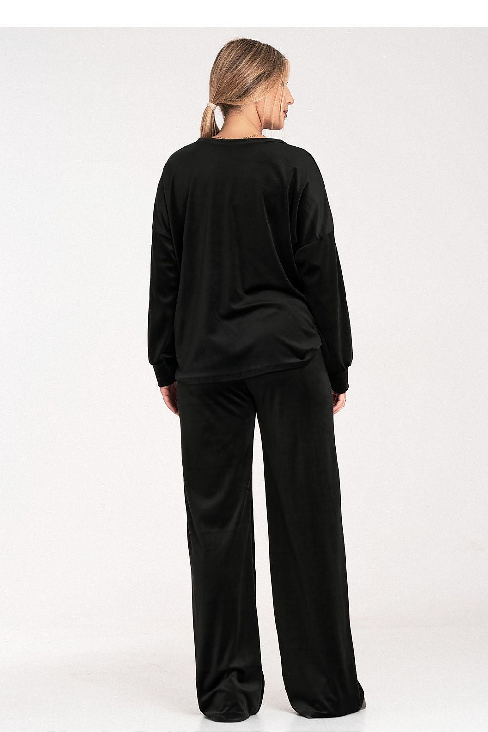 Person wearing a black outfit on a white background