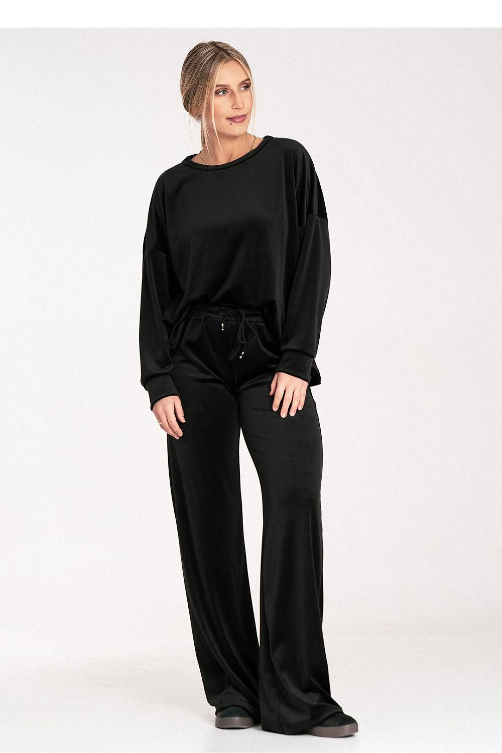 Woman wearing a black outfit on a white background