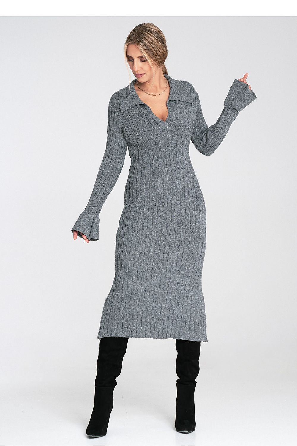 Woman wearing a gray ribbed dress with long sleeves on a white background