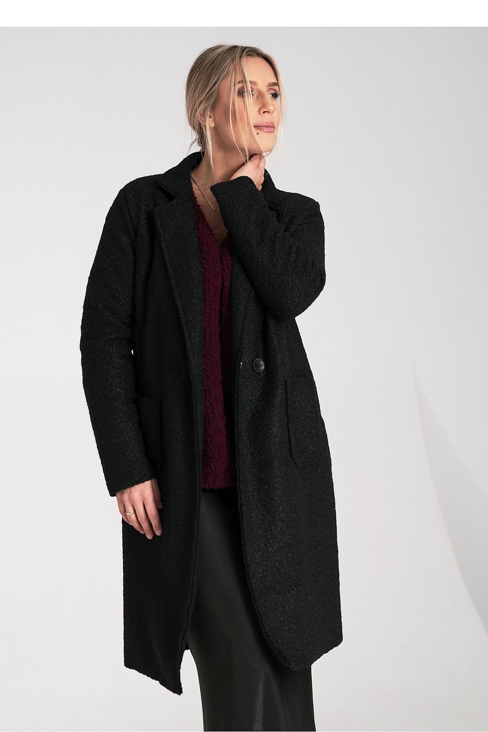 Woman wearing a black coat on a white background