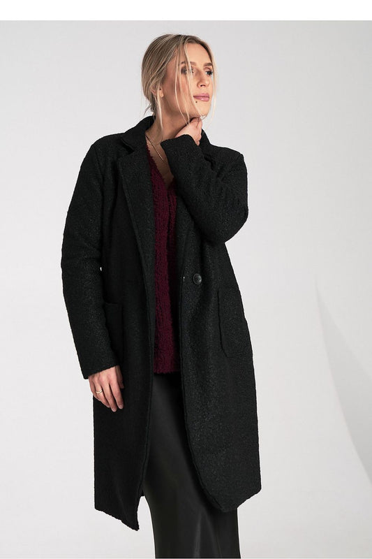 Woman wearing a black coat on a white background