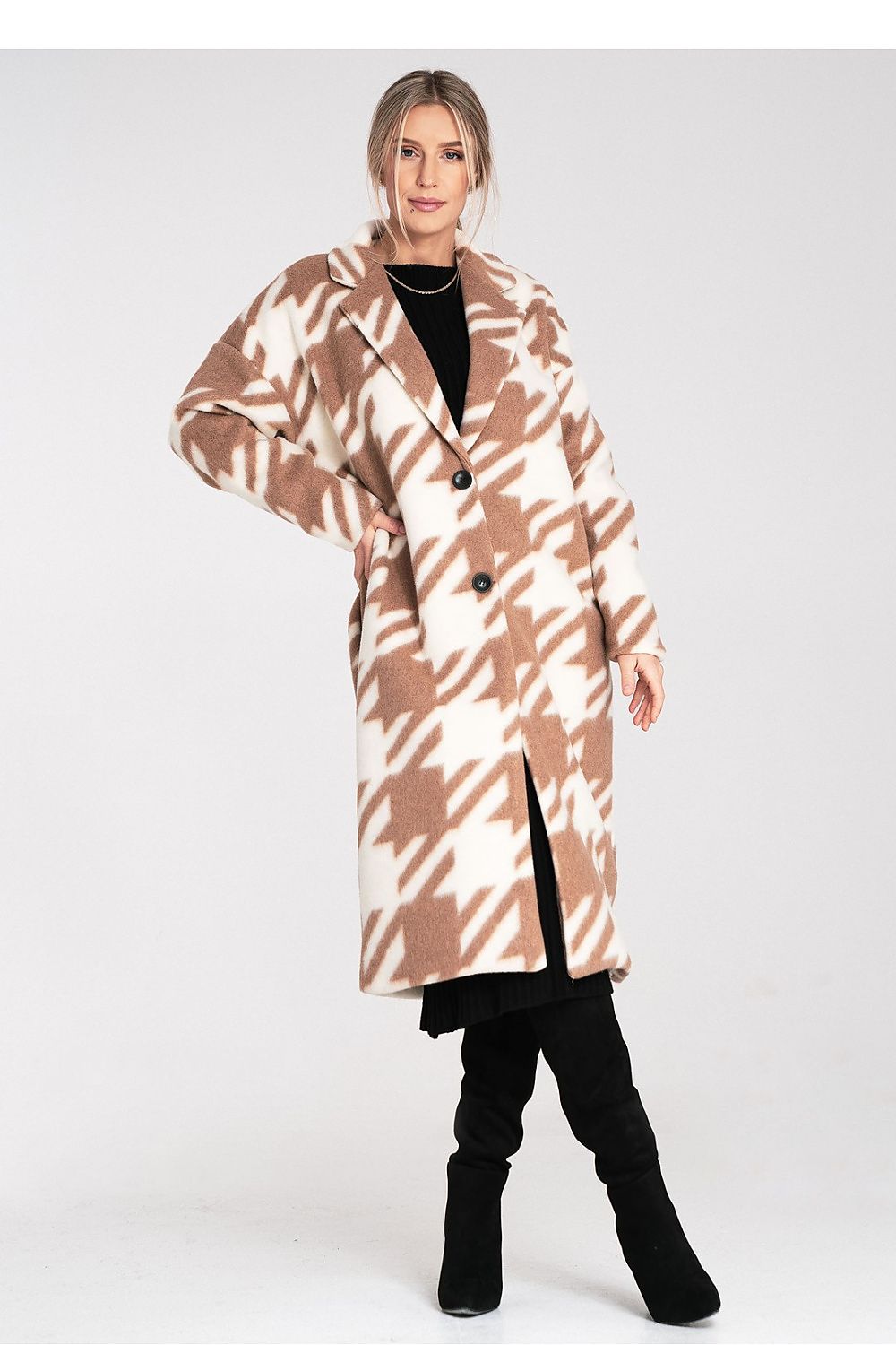 Woman wearing a patterned coat on a white background