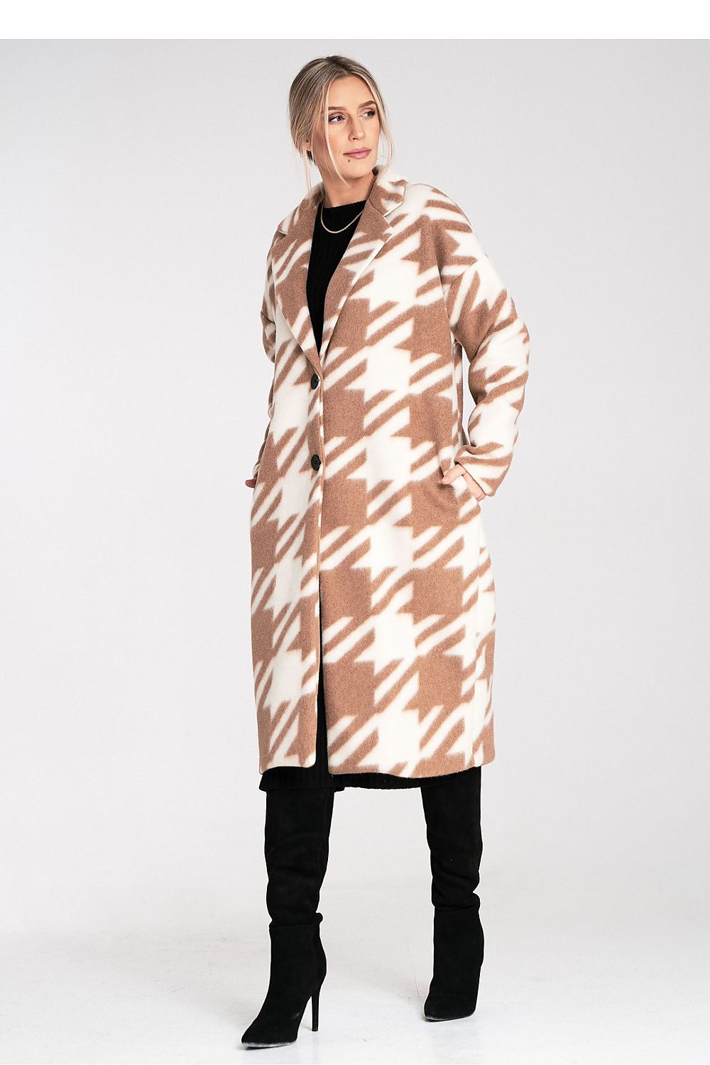 Woman wearing a patterned coat on a white background