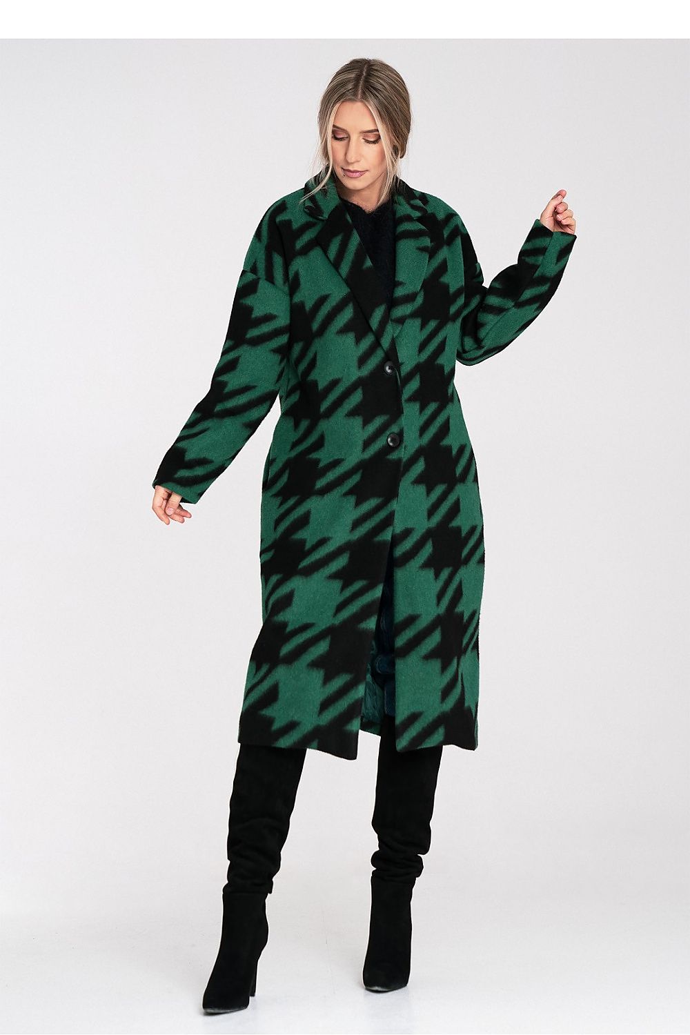 Woman wearing a green and black checkered coat on a white background