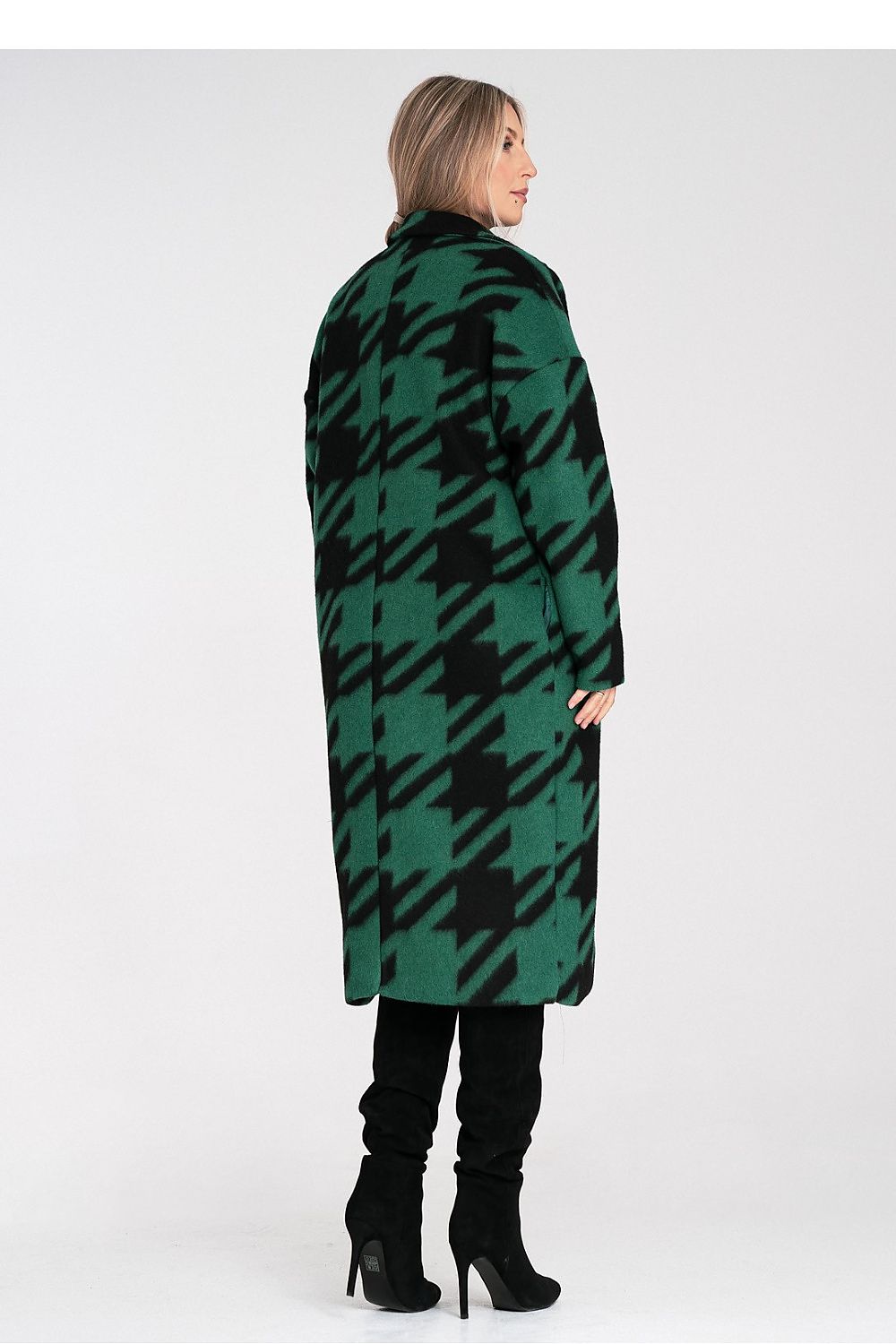 Person wearing a green and black checkered coat on a white background