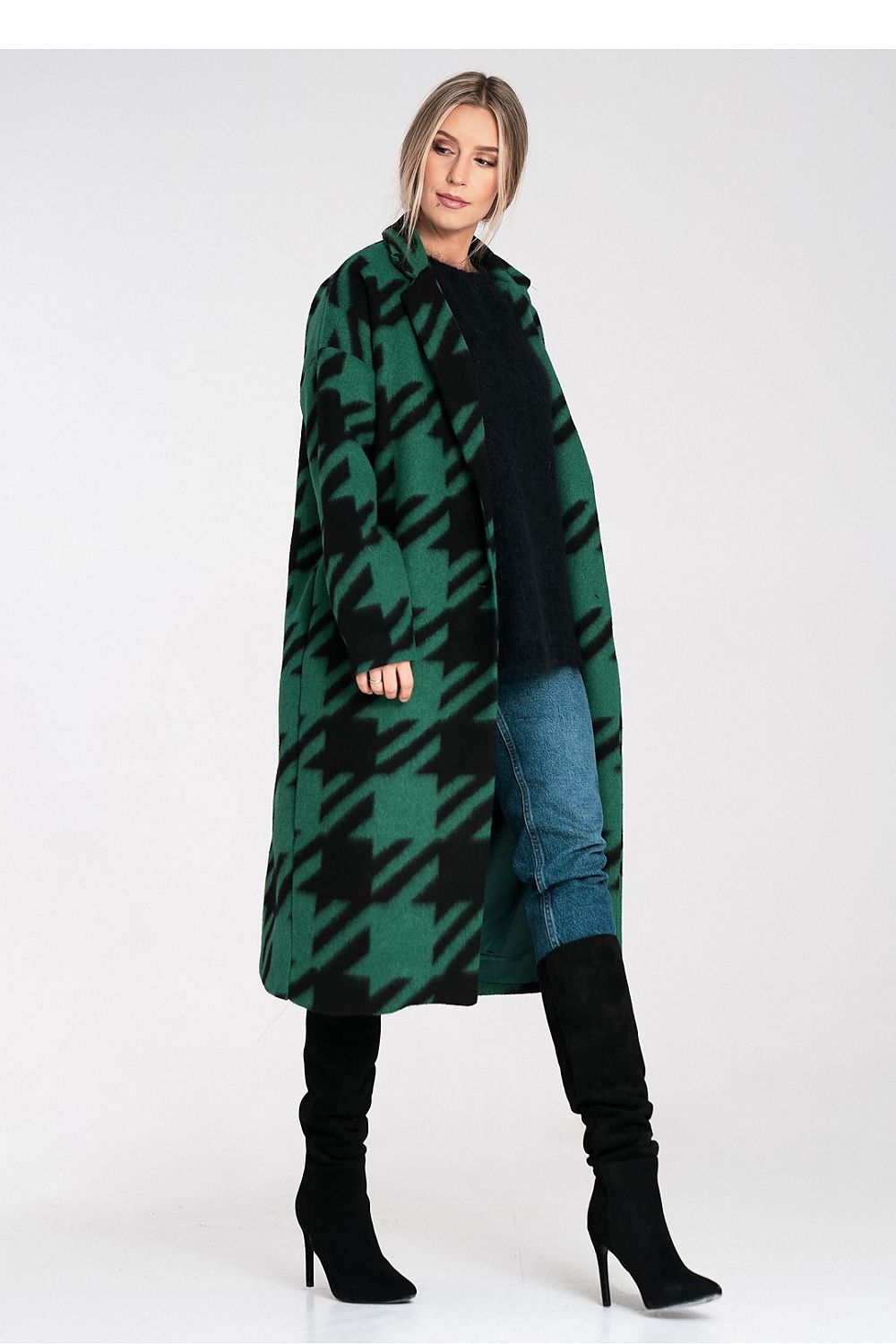 Woman wearing a green and black plaid coat on a white background