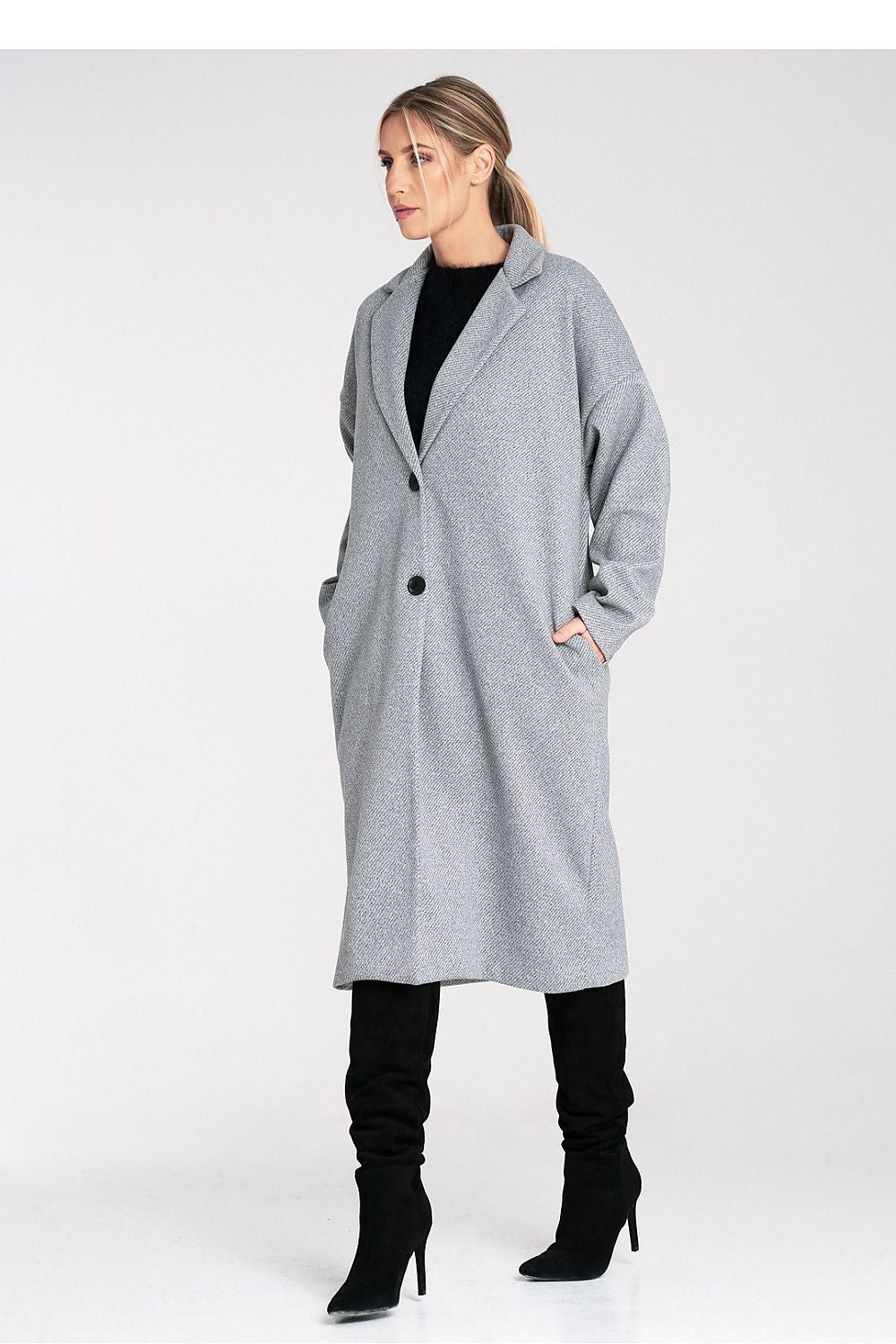 Woman wearing a gray coat on a white background
