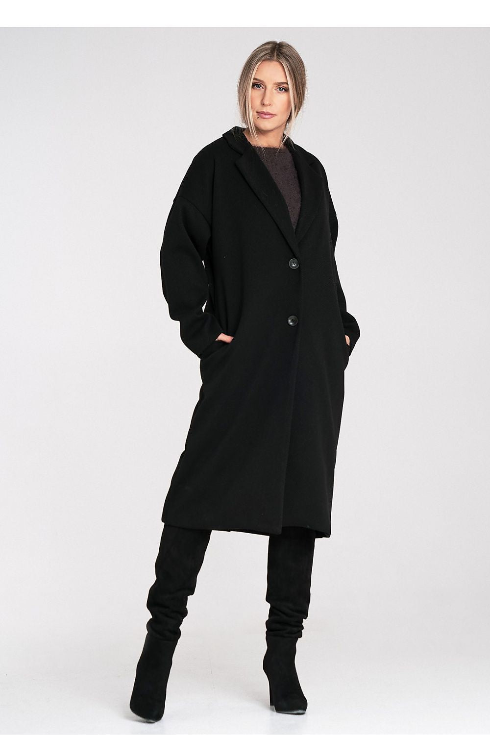 Woman wearing a black coat on a white background