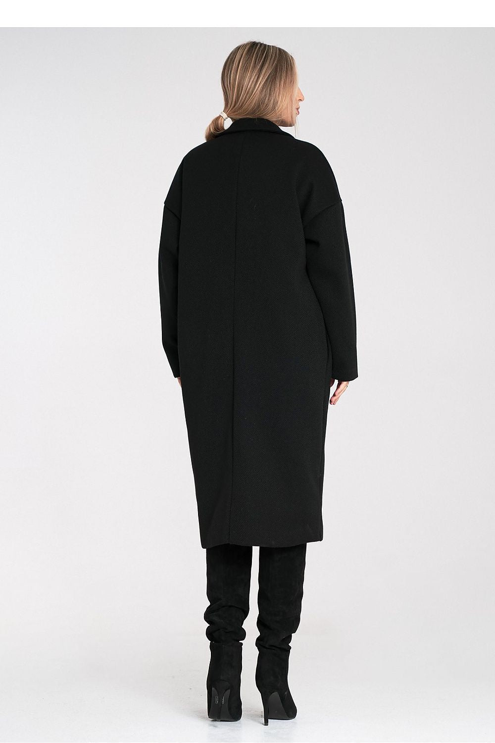 Woman wearing a black coat on a white background