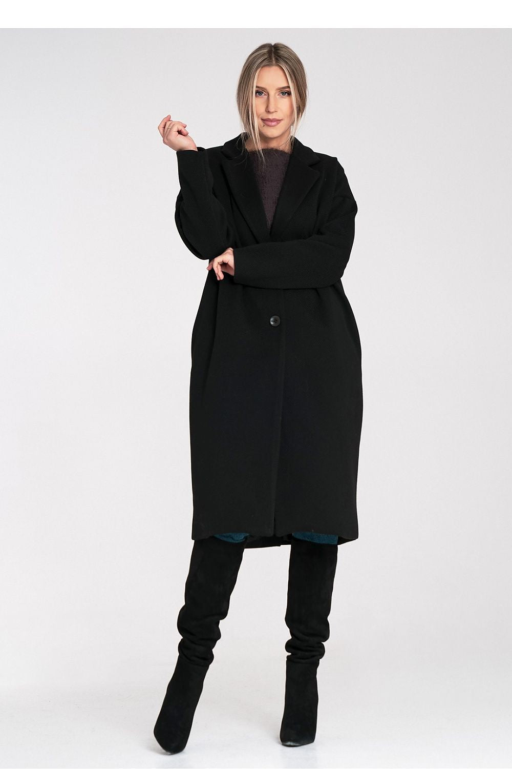 Woman wearing a black coat on a white background