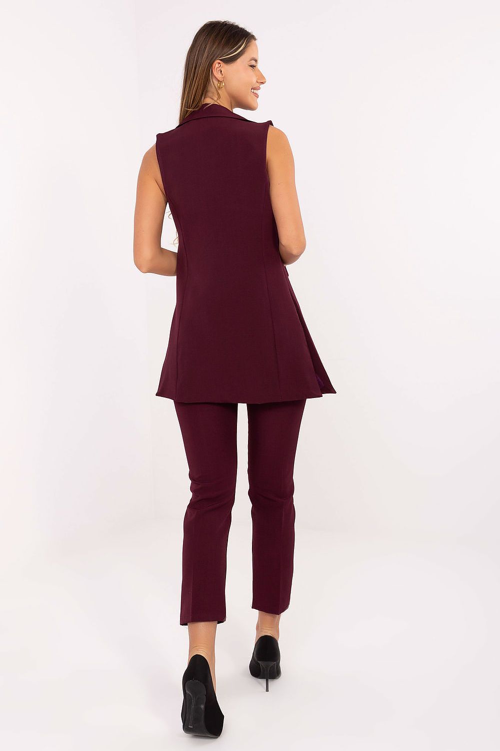 Back view of red gilet highlighting structured tailoring.