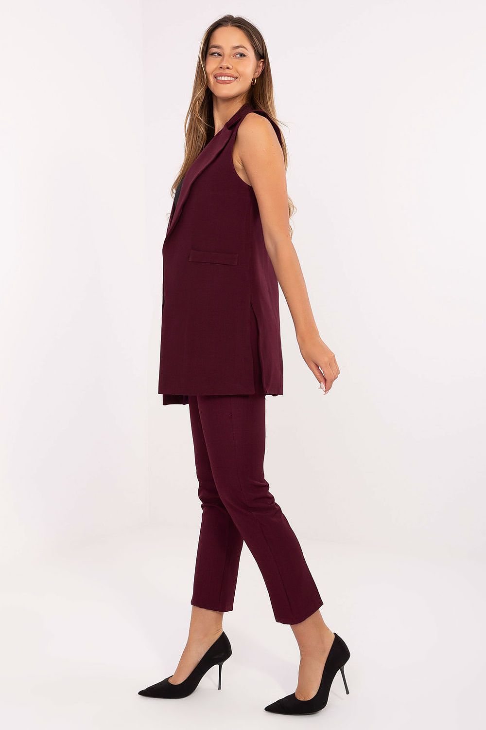 Side view of red women’s longline vest styled over casual outfit.