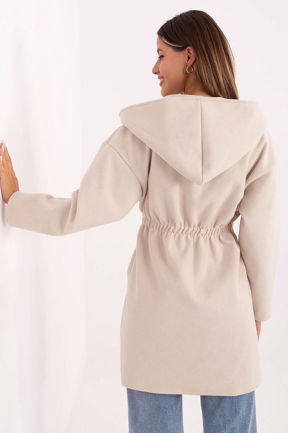 Back view of beige coat with oversized hood design.