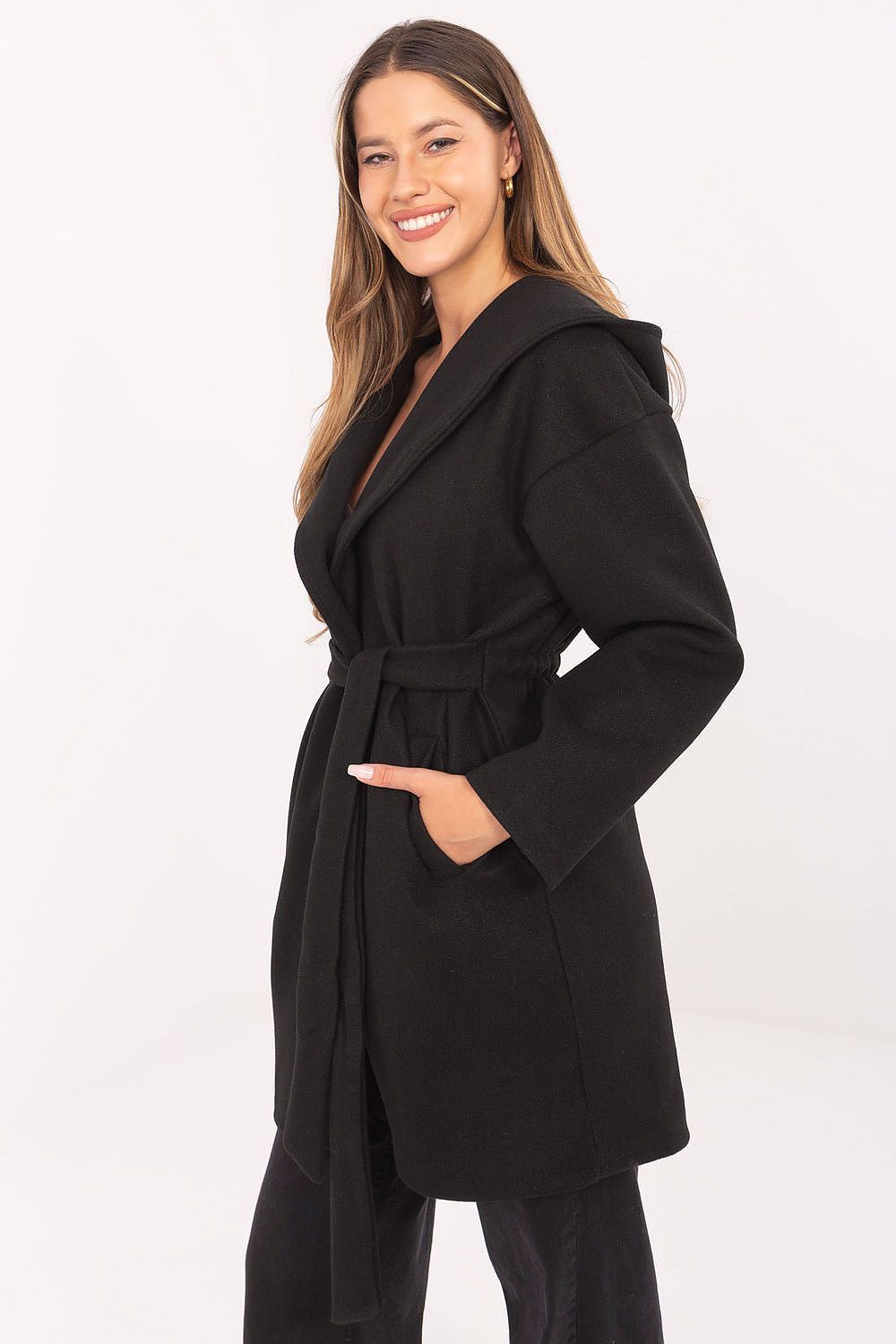  Side view of black belted coat showing longline cut.