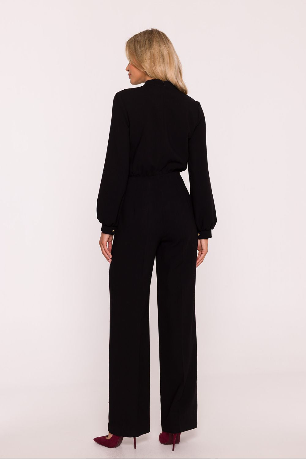 Woman wearing a black outfit on a white background