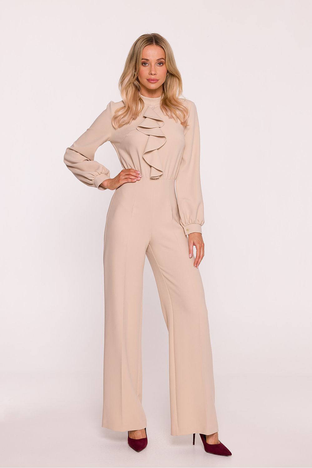 Woman wearing a beige jumpsuit on a white background