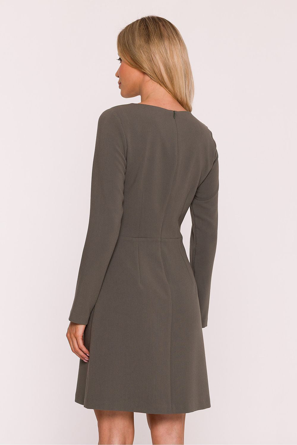 Woman wearing a green dress on a white background