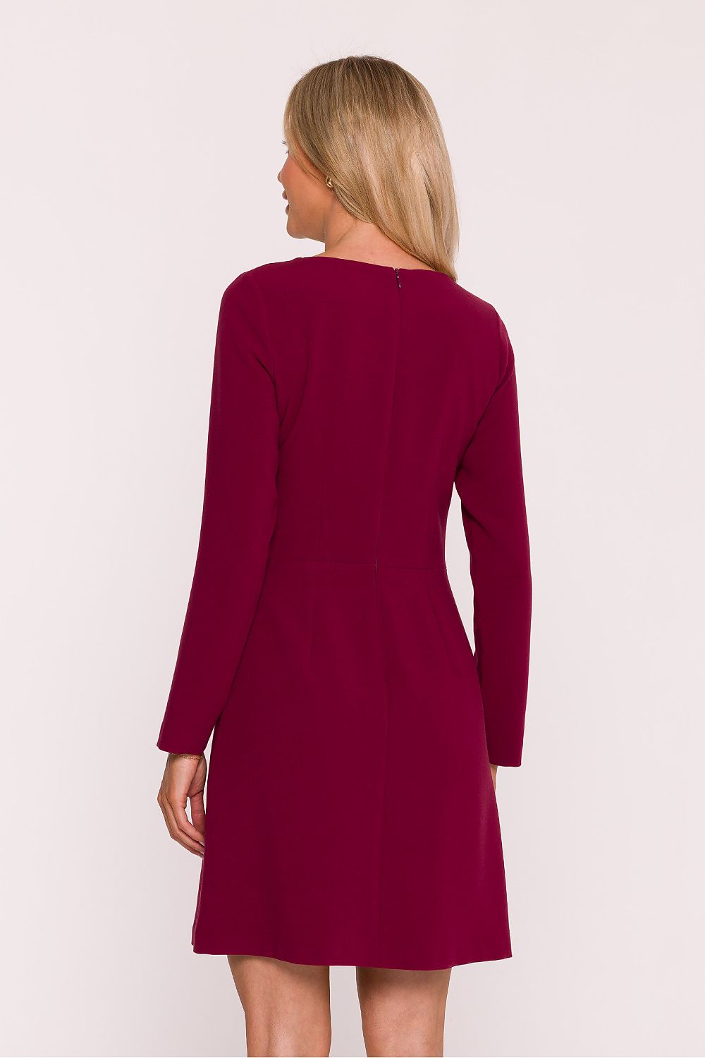 Woman wearing a burgundy dress on a white background