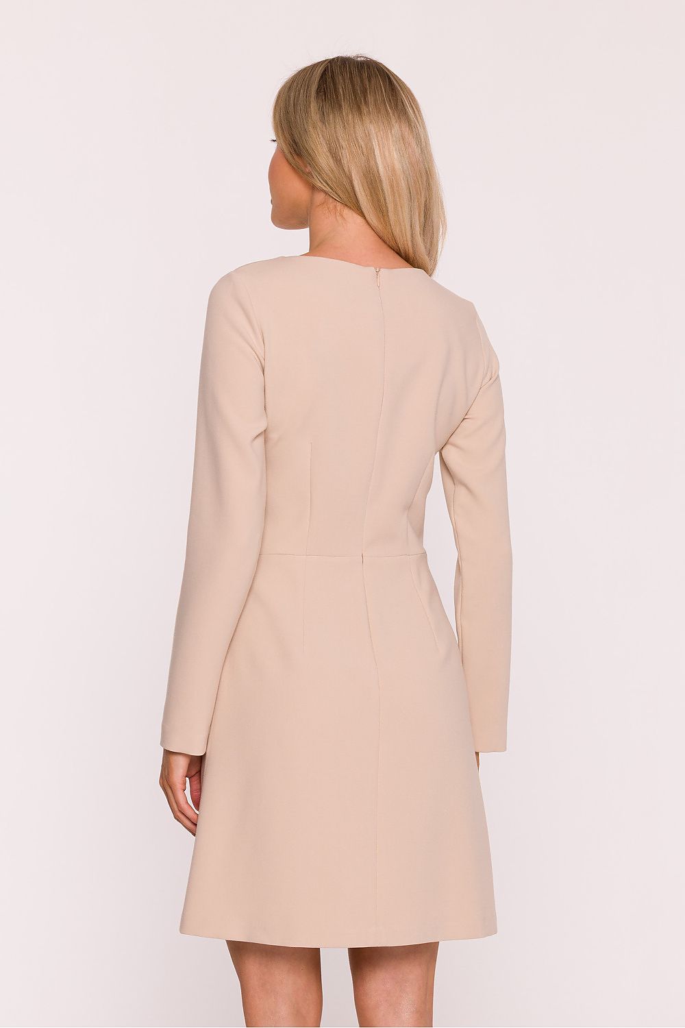 Beige dress worn by a person on a white background