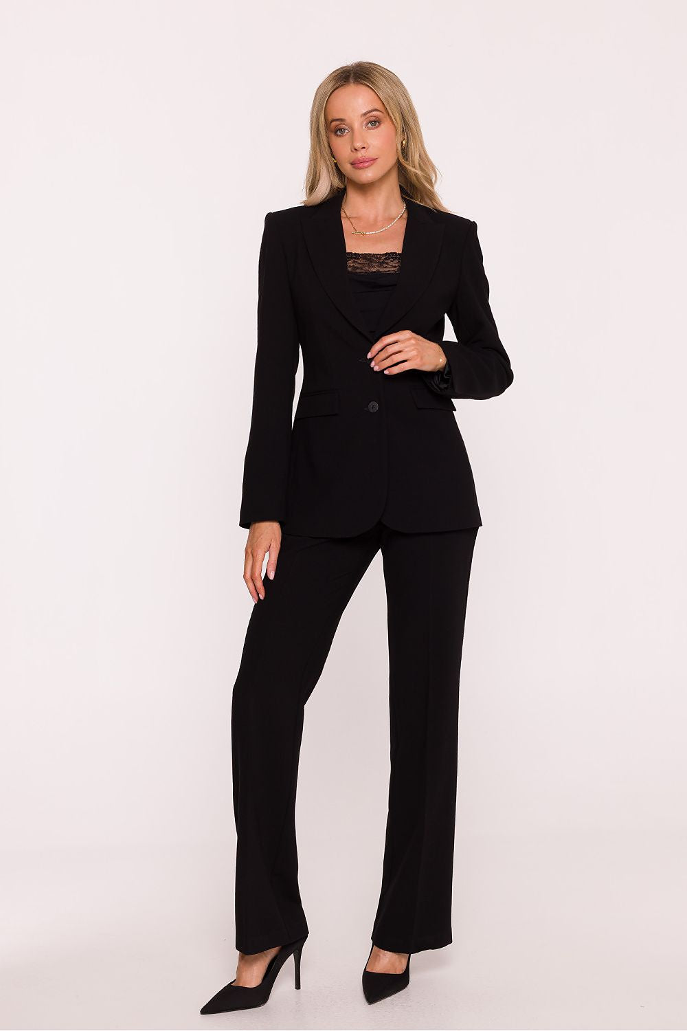 Woman wearing a black suit on a white background