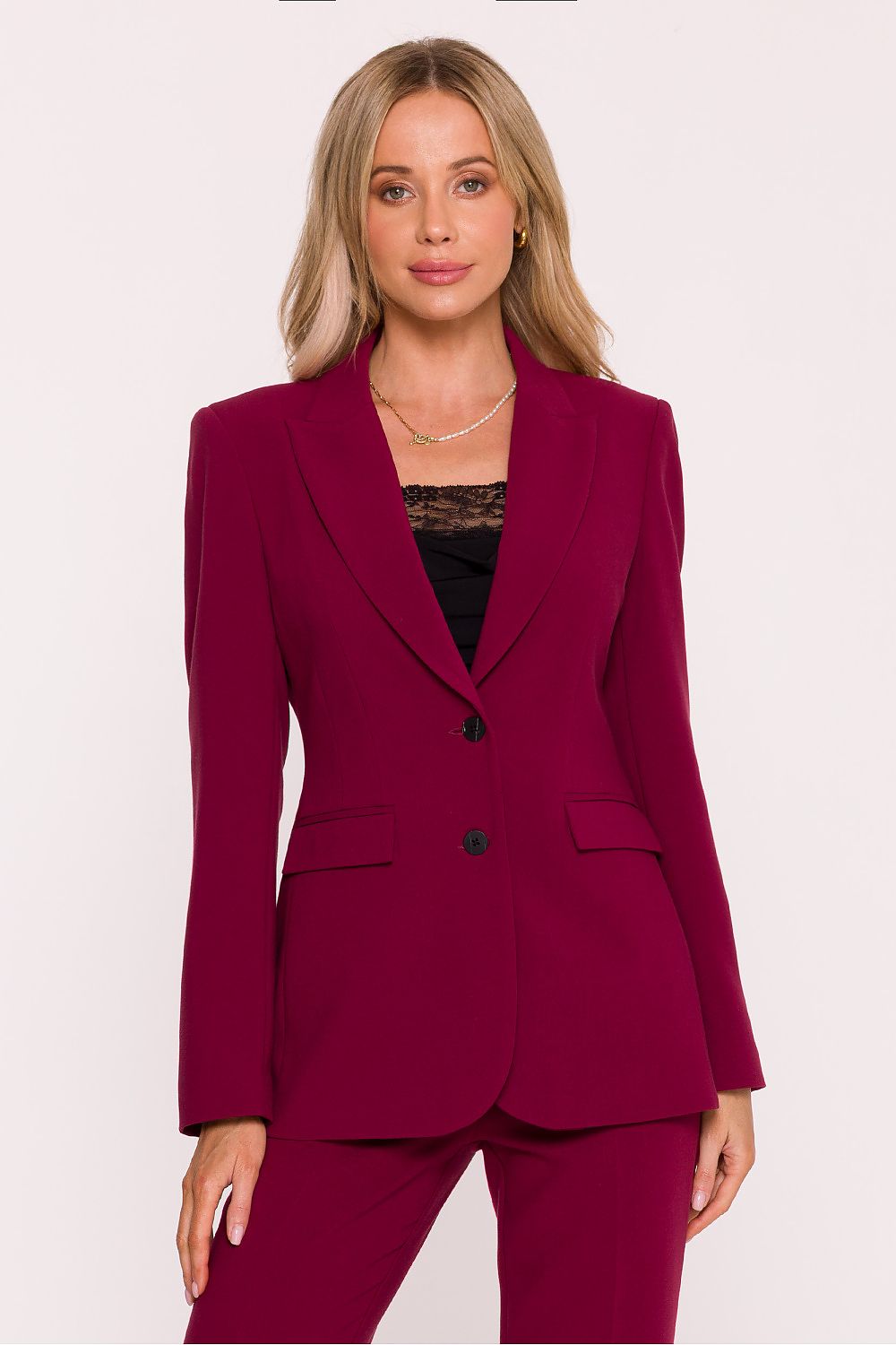 Woman wearing a burgundy suit on a white background