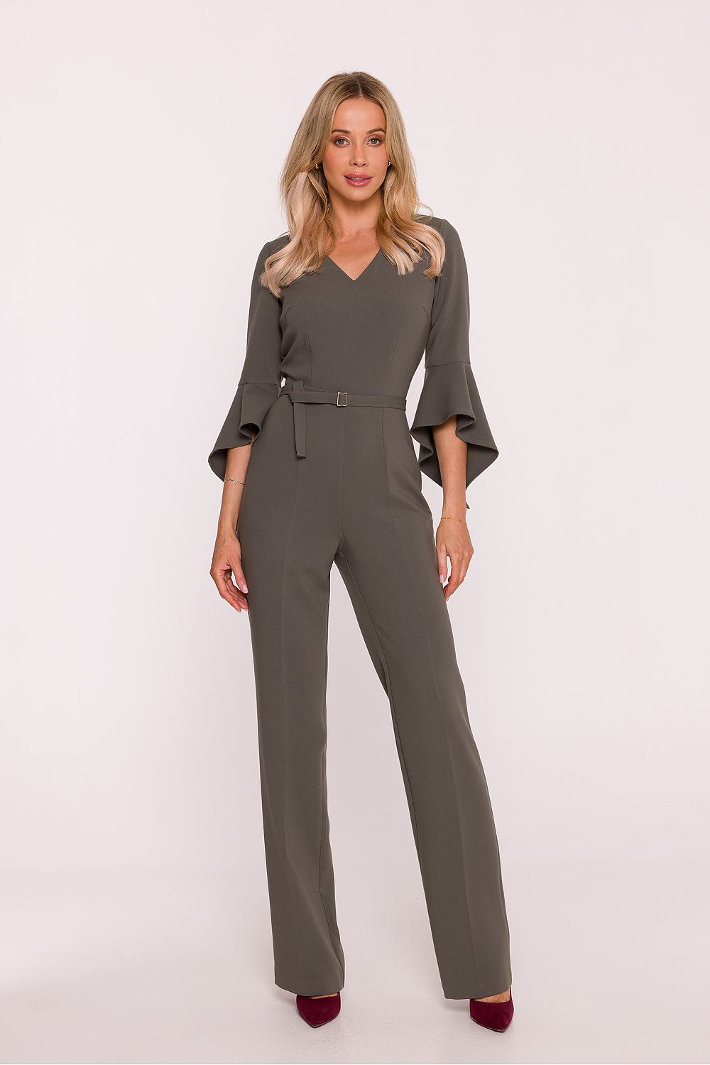 Woman wearing a gray jumpsuit on a white background