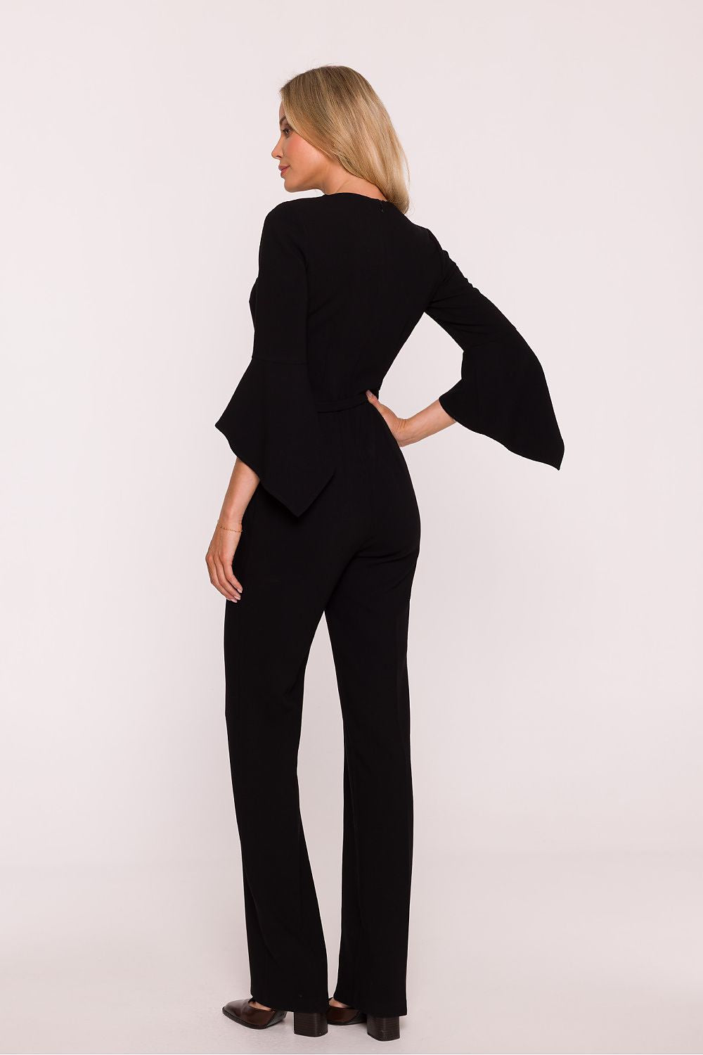 Woman wearing a black suit on a white background