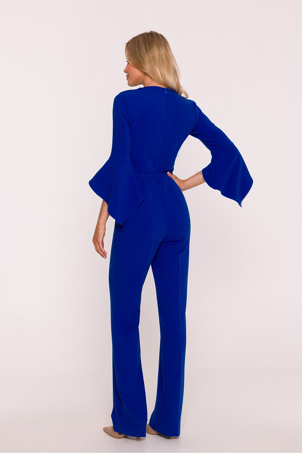 Woman wearing a blue jumpsuit on a white background