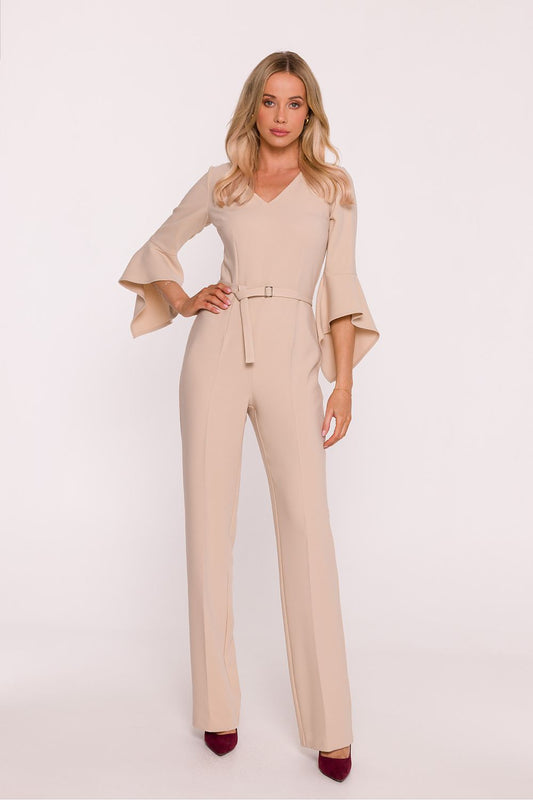 Woman wearing a beige jumpsuit on a white background