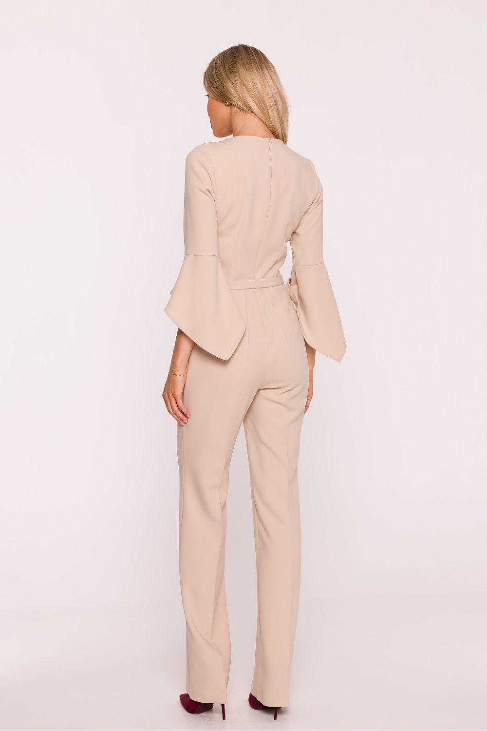 Woman wearing a beige suit on a white background