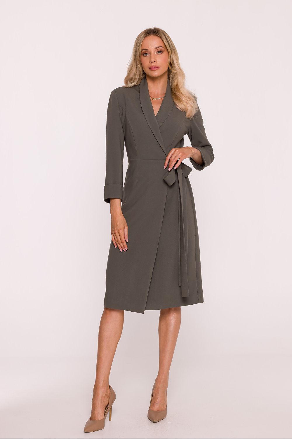 Woman wearing a gray wrap dress on a white background