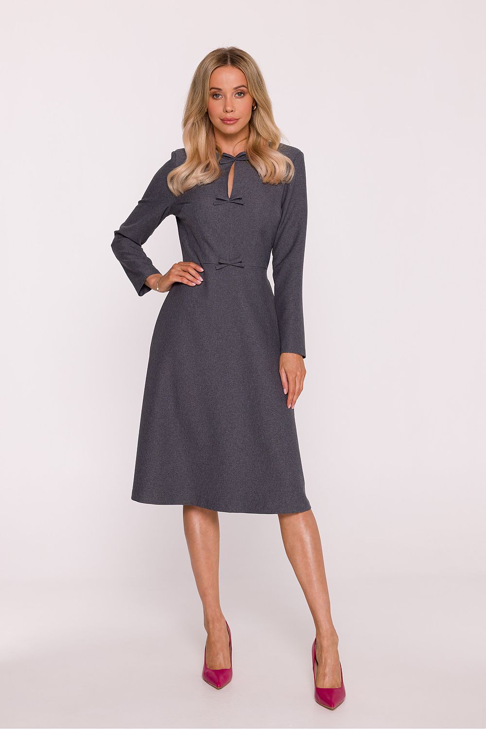 Woman wearing a gray dress on a white background