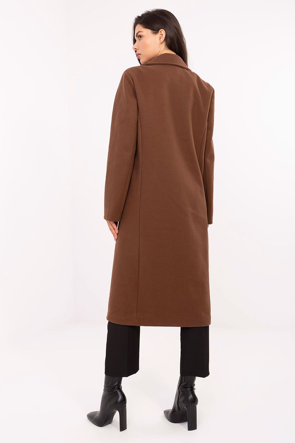 Woman wearing a brown coat on a white background