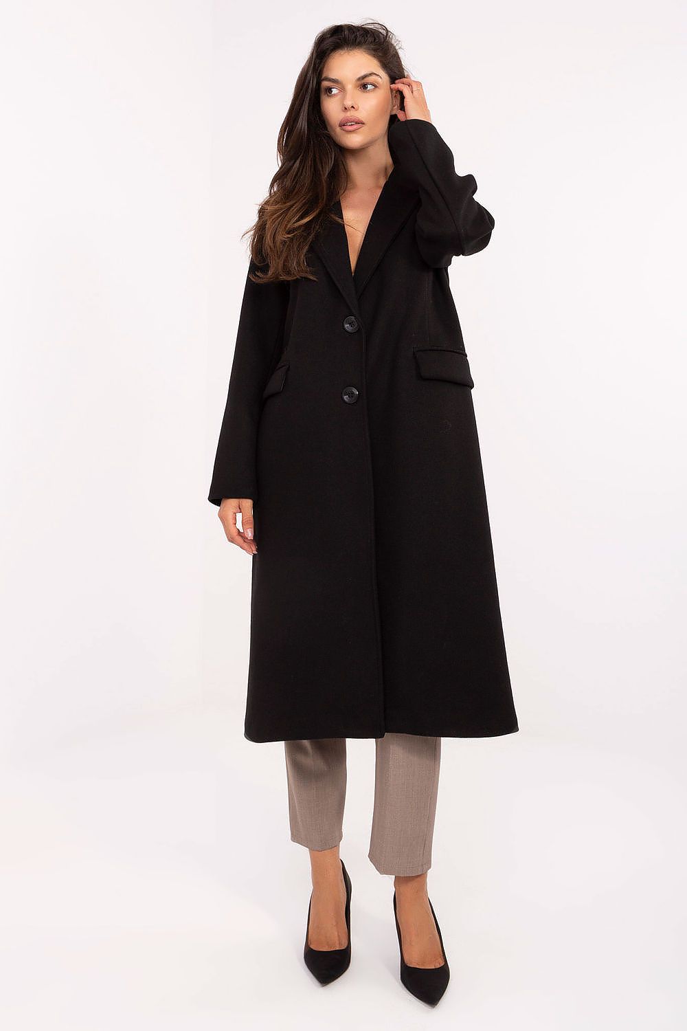Woman wearing a black coat on a white background