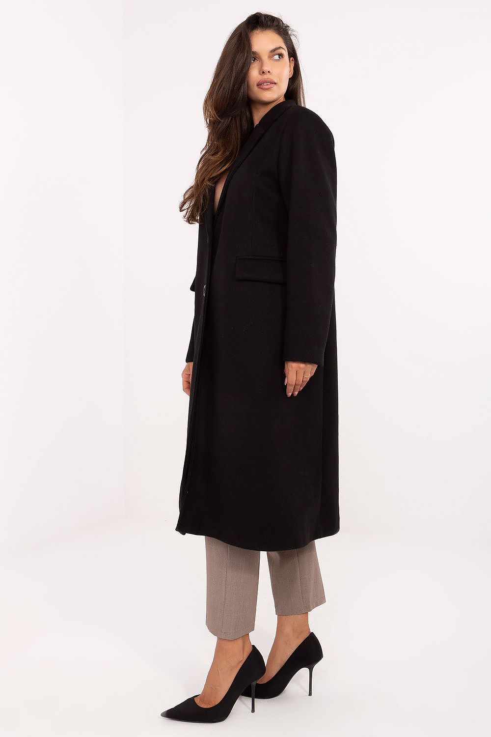 Woman wearing a black coat on a white background