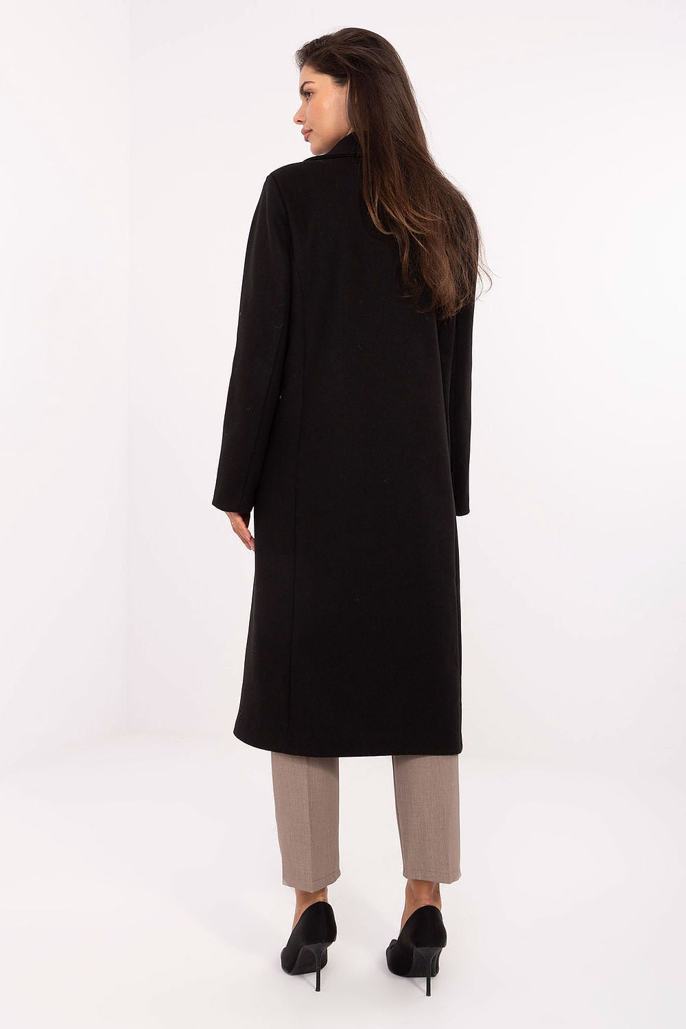 Woman wearing a black coat on a white background