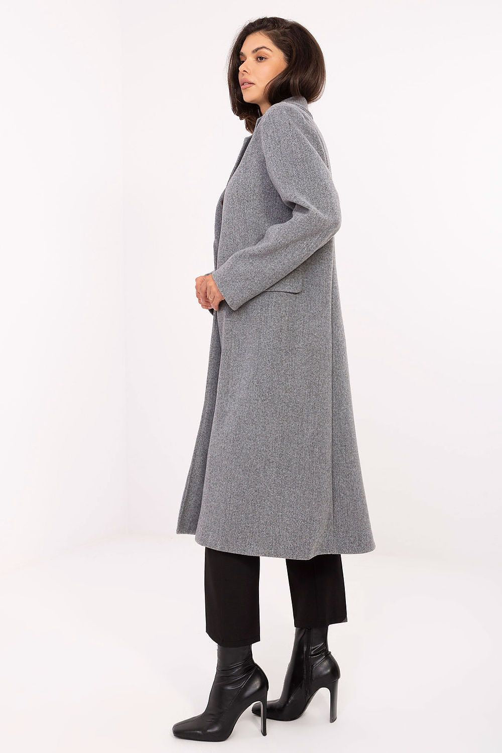 Woman wearing a gray coat on a white background