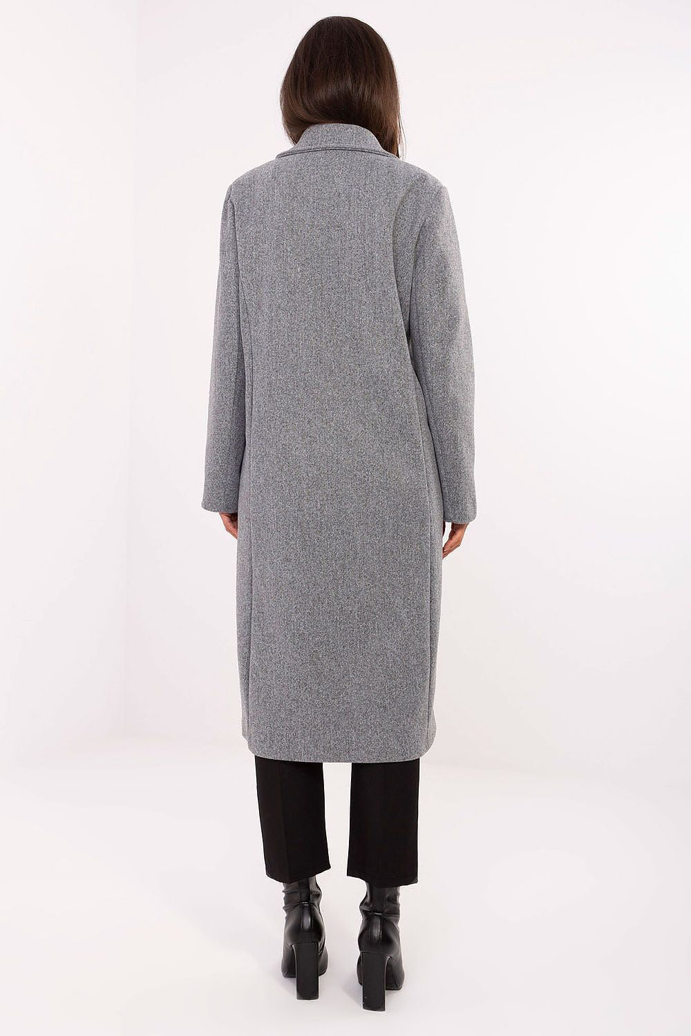 Person wearing a long gray coat on a white background