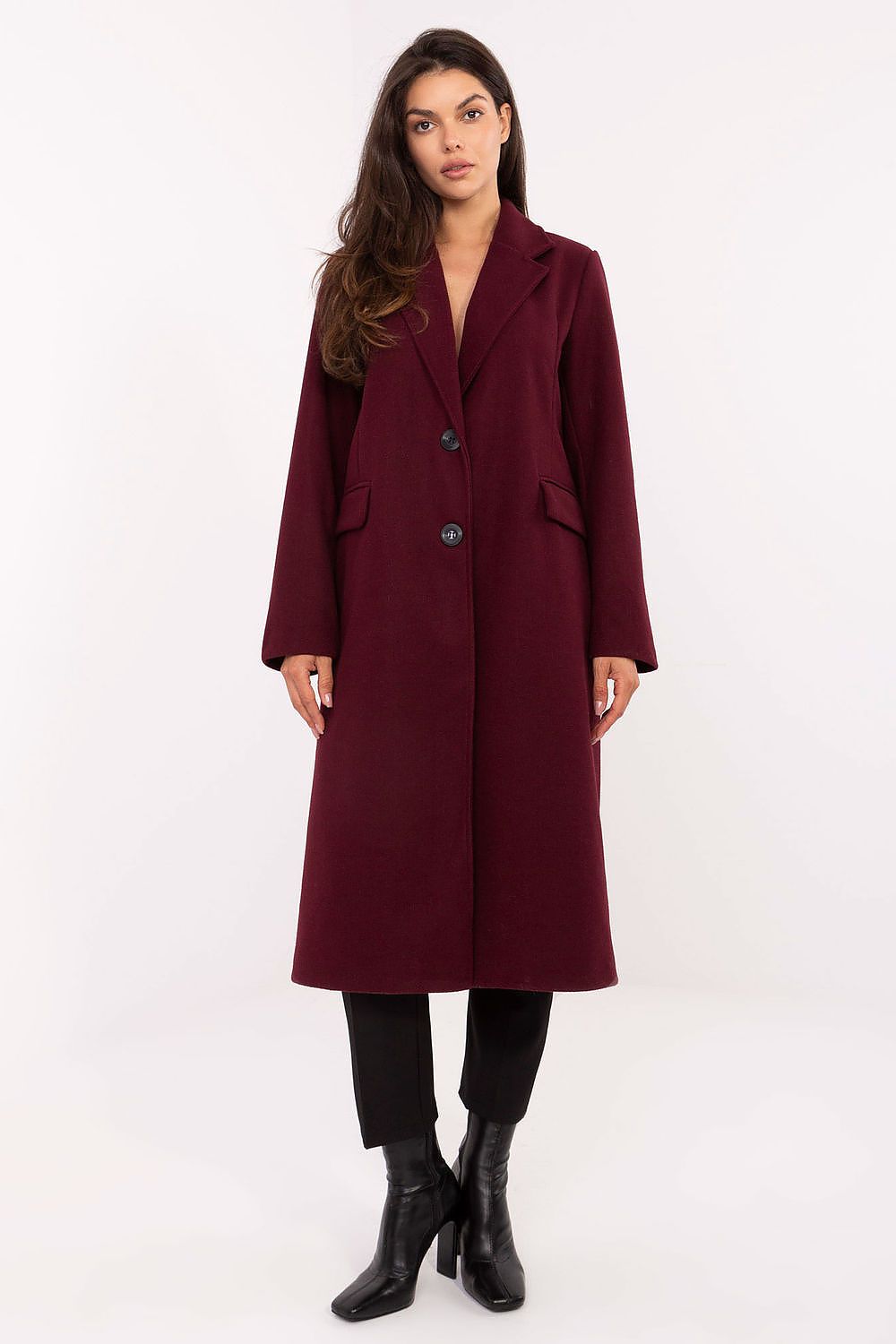 Woman wearing a burgundy coat on a white background