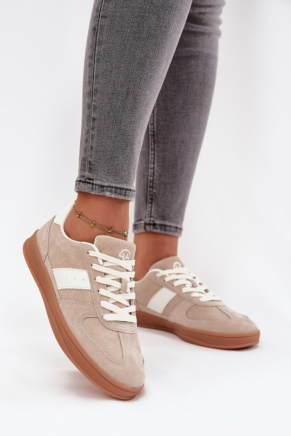 Side view – Beige sneakers showing rubber outsole and soft suede texture.