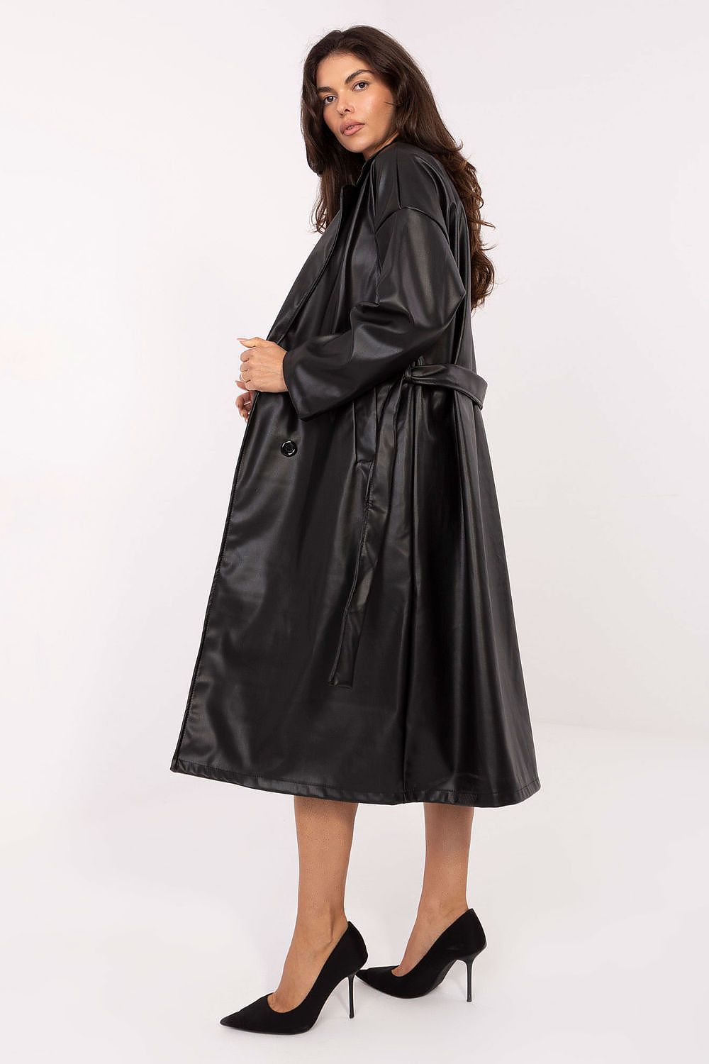  Side angle showing sleek texture and elegant silhouette in black leather coat.
