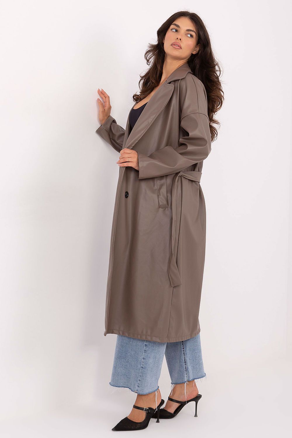 Side view showcasing tie belt and smooth finish of beige coat.