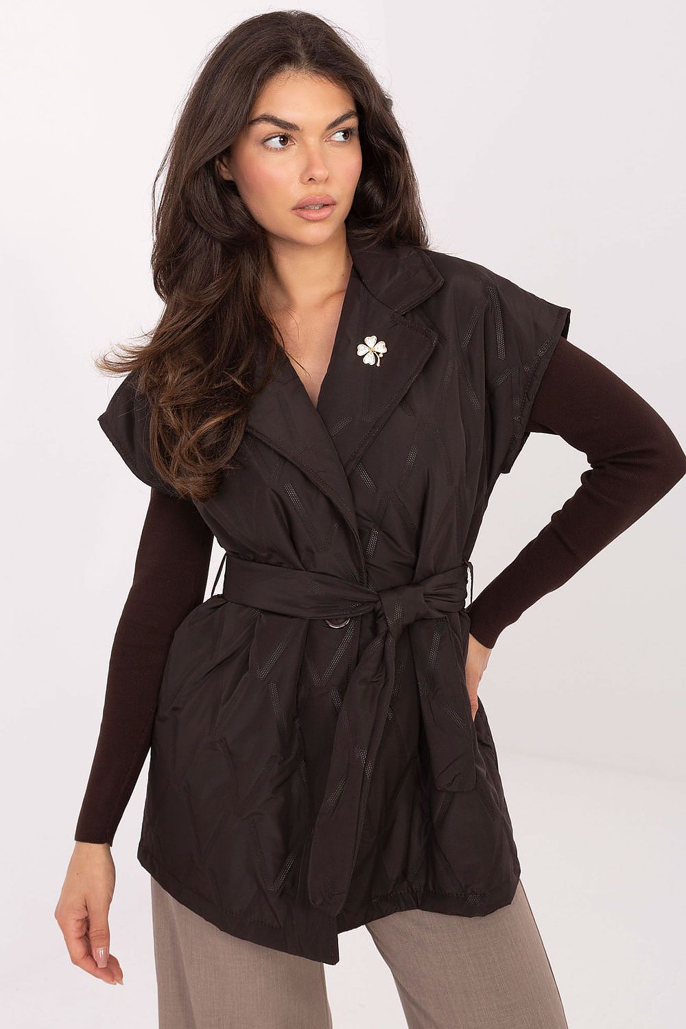 Front view of Elara Women’s quilted vest in chocolate brown with lapels and tie belt.