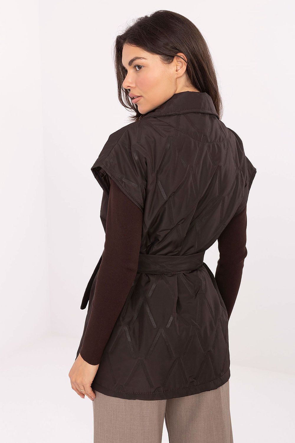  Back view of Elara quilted vest in brown showing tie belt and elegant silhouette.