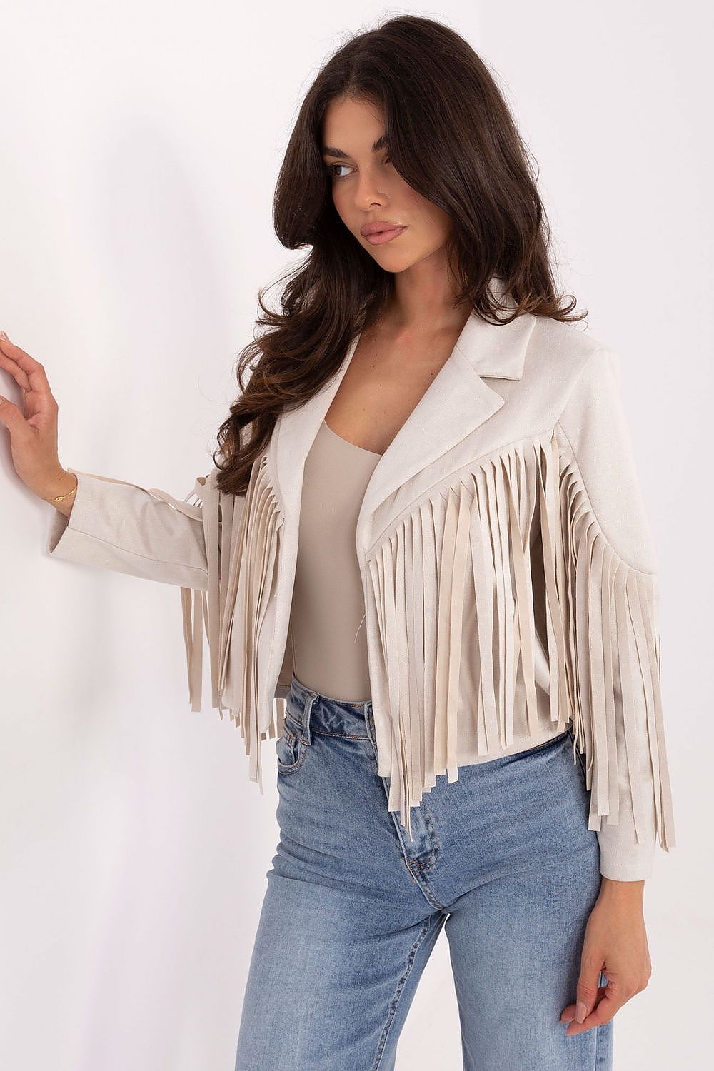 Side view – Beige jacket highlighting fringe detail and comfortable cut.