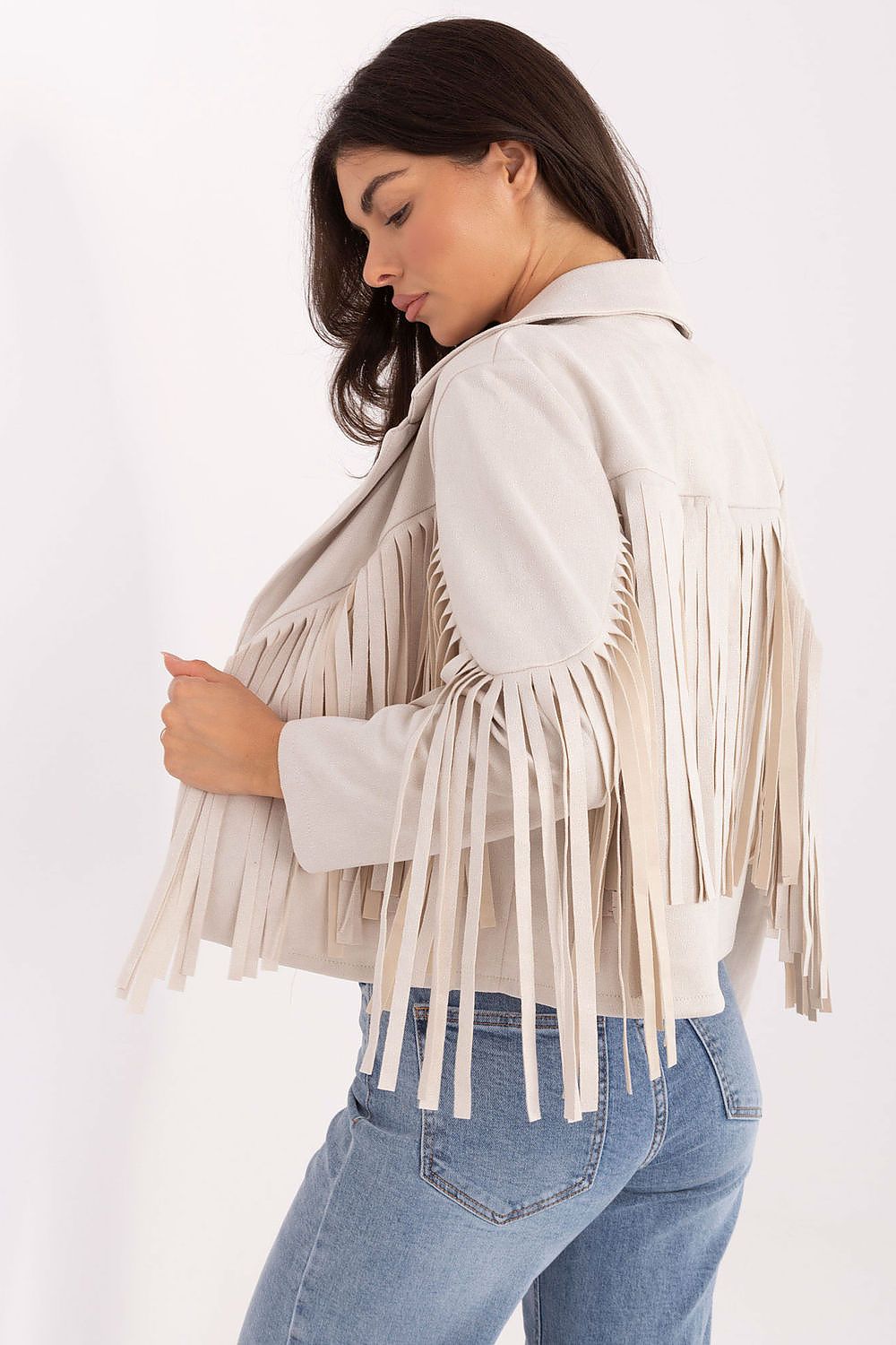 Back view – Beige jacket with flowing fringe detailing on sleeves and back.