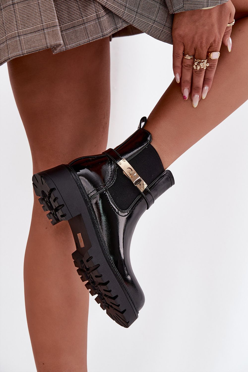 Side view highlighting gold strap detail and platform sole on Aria ankle boots.