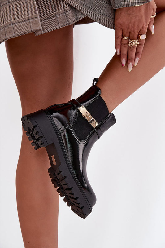 Side view highlighting gold strap detail and platform sole on Aria ankle boots.