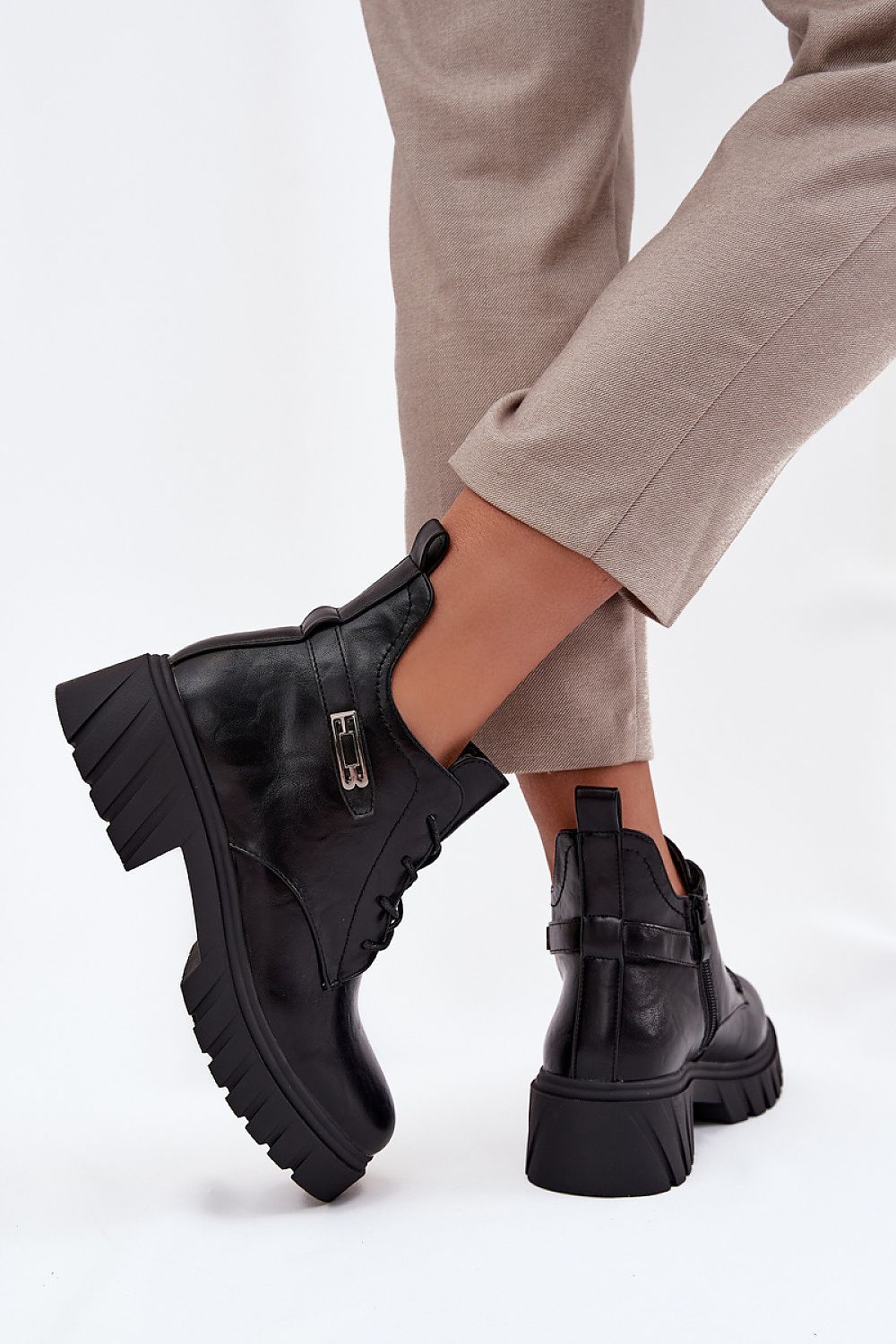 Side view – Close-up of lacing and zipper on eco leather ankle boots.