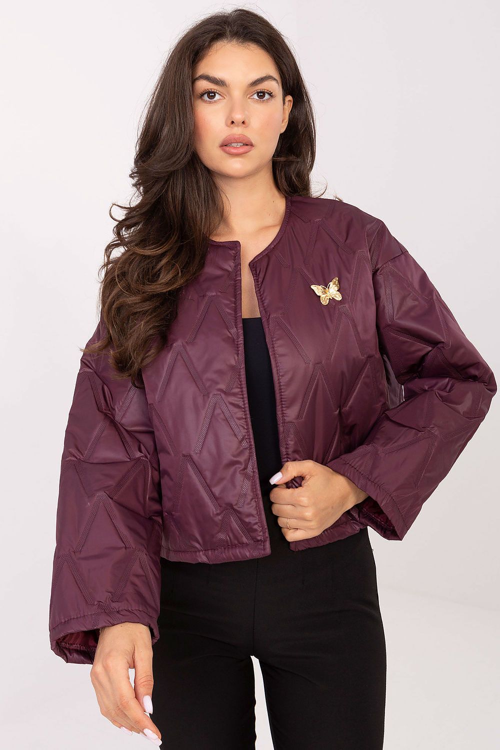 Front view of Selene Women’s quilted jacket with collarless design, subtle quilting, and butterfly-shaped brooch.